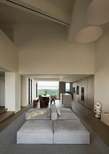 A modern living room featuring neutral-toned furniture and decor.