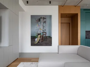 A modern minimalist living room featuring concrete walls and wood elements.