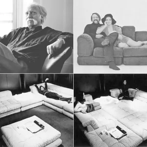 A black and white image showcasing a comfortable sofa with people relaxing on it.