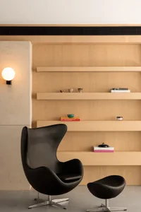 A minimalist living space featuring wooden shelves.
