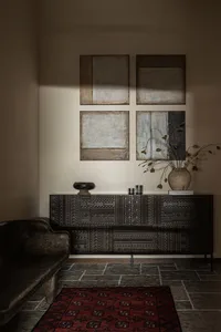A room featuring industrial interior design with wooden furniture and patterned wood panels.