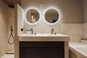 Modern bathroom with round mirrors and double sinks