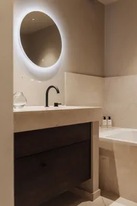 Modern bathroom featuring a marble countertop and sink with minimalist design elements.