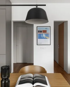 A modern home office with a wooden desk and white walls.