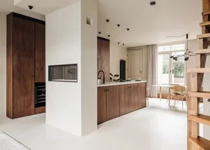 A modern kitchen with wooden cabinets and a minimalist design.