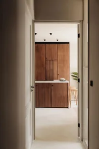 A modern kitchen with wooden cabinets and a minimalist design.