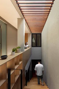A modern minimalist interior space featuring wooden paneling and a sleek, open design.