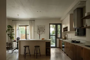 Modern, minimalist kitchen with wooden cabinets and a central island.