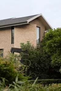Modern residential house with brick exterior and a gable roof.