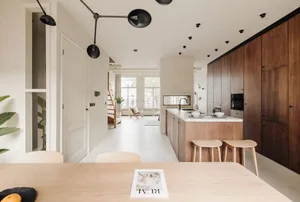 Modern residential kitchen with wooden materials and sleek, minimalist design.