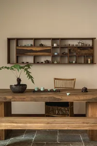 A tea room featuring wooden furniture and a shelf with various tea pots.