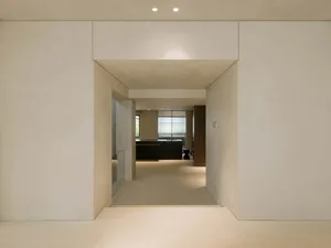 A minimalist interior space featuring concrete walls and flooring.
