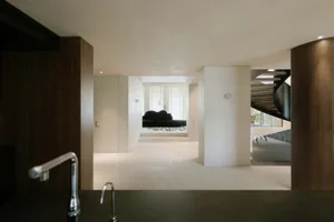 A modern residential living room featuring a combination of wooden and concrete elements.