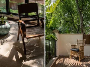 A wooden armchair placed outdoors in a shaded area surrounded by greenery.