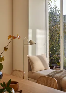 A minimalist living space with neutral-toned fabrics and a sleek, modern design.