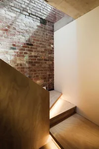 Industrially styled staircase with brick wall and concrete elements