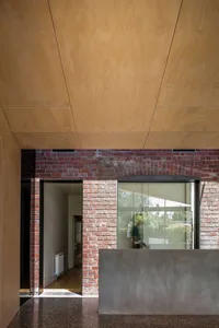 Modern interior with brick wall and wooden ceiling.
