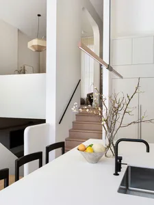Contemporary kitchen with minimalist design, featuring concrete cabinets and stainless steel appliances.