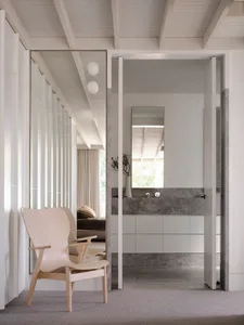 Modern, minimalist bathroom with concrete accents and a sleek, open design.