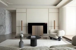 Modern, minimalist living room featuring marble accents, wood furniture, and leather seating.