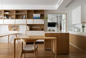 Minimalist living room with wooden furniture and open shelving.