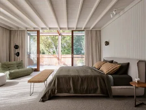 A modern bedroom featuring wood, fabric, and glass elements.