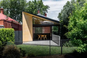 A modern house with large glass panels on the exterior.