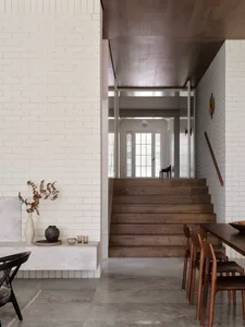 Modern interior design featuring wood, concrete, and brick surfaces.