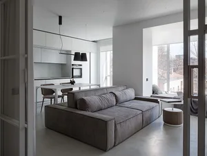 A modern living room with light grey upholstered furniture and minimalist design.