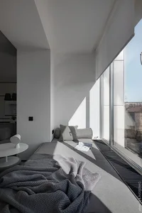 A minimalist library space with modern materials and a comfortable seating area