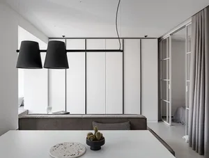 Modern minimalist residential interior featuring a terrazzo table with decorative objects.