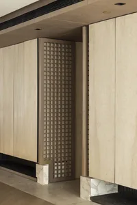 A minimalist interior design featuring wooden cabinets with a lattice panel.