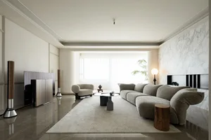 A modern living room featuring sandstone marble flooring and minimalist furniture design.