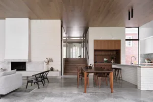 Modern residential kitchen featuring concrete, brick, and wood materials with a minimalist design.