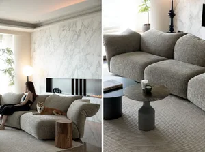 A modern living room with a textured sofa, marble fireplace, and concrete coffee tables.