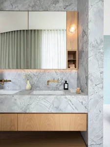 Modern bathroom featuring a marble countertop and wooden cabinets