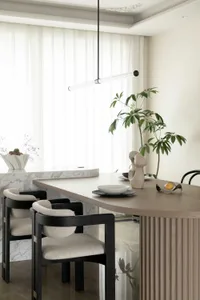 A modern dining room with a wooden dining table, marble accents, and minimalist design elements.