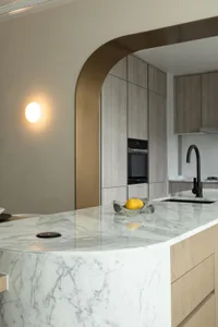 Modern kitchen with marble countertops and wooden cabinets
