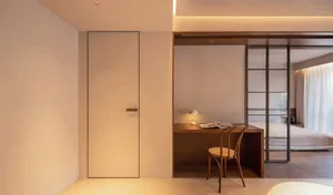 Modern minimalist bedroom featuring wooden furniture and soft lighting.