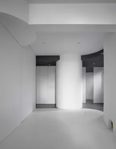 A minimalist interior featuring white walls and floor.