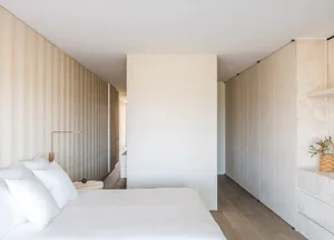 Modern minimalist bedroom featuring neutral colors and simple design elements.