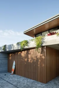 Modern building exterior with wood siding and concrete elements.
