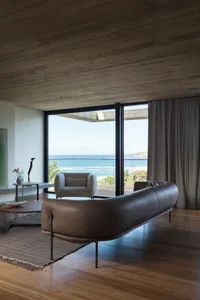 Contemporary living room featuring modern leather furniture and concrete ceiling