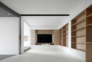 Modern minimalist living room with white walls and wooden furniture.