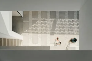A minimalist staircase with a concrete floor.