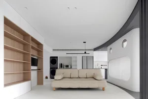 A modern minimalist living room with white and wood furniture and metal accents.