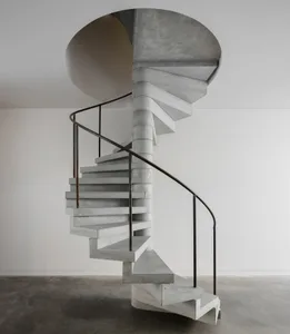 Concrete spiral staircase with black metal handrail