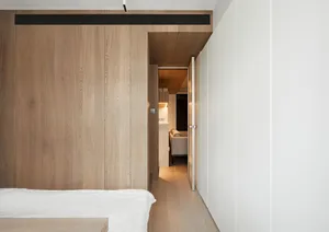 Modern minimalist bedroom featuring wood paneling