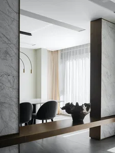 Modern dining room featuring marble materials and elegant furniture.