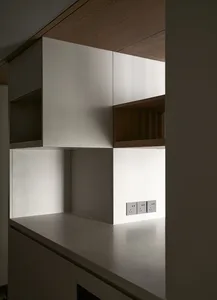 Modern minimalist kitchen with white concrete countertops and sleek, clean lines.